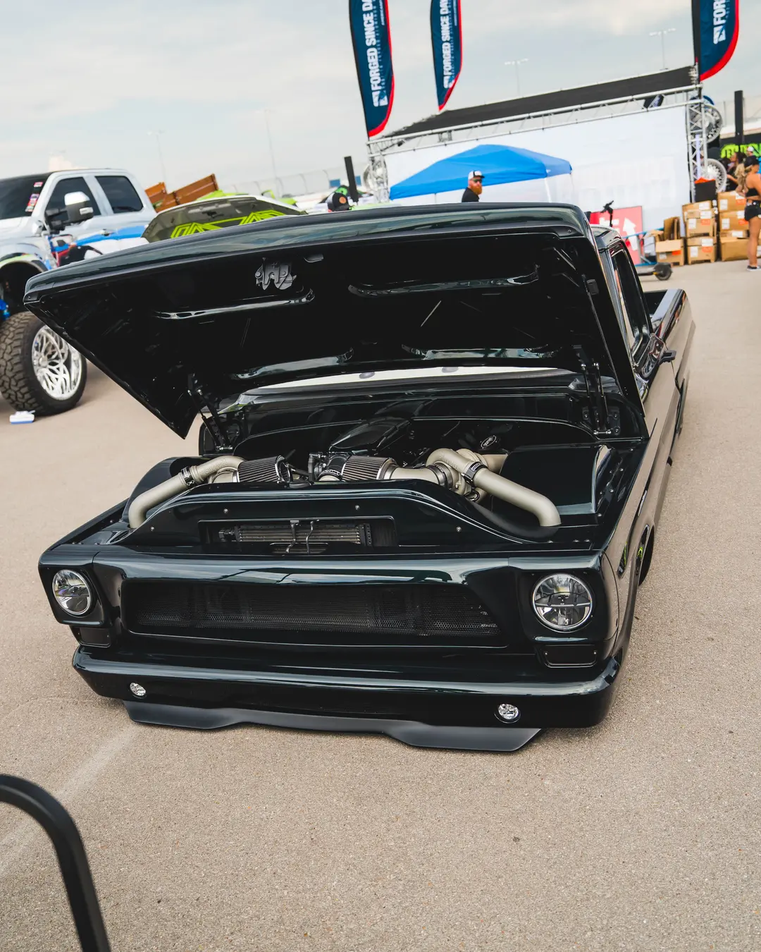 Black twin-turbo classic pickup with its hood open
